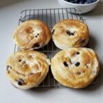 Blueberry bagels cooling on a counter