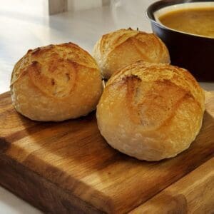 Three rolls on a wooden board.
