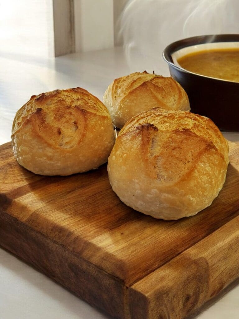 Three rolls on a wooden board.