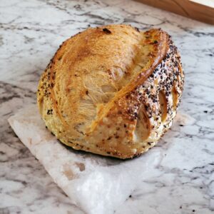 Loaf of bread on marble countertop.