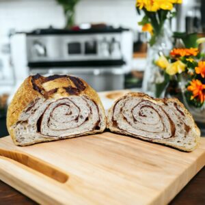 Sliced cinnamon bread on wooden cutting board.