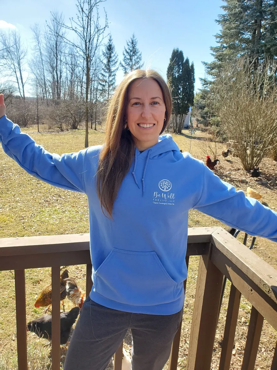 Woman smiling on a sunny outdoor deck.