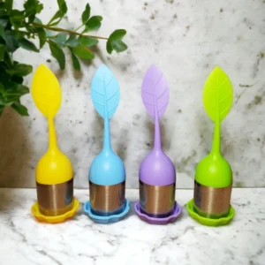 Colorful leaf-shaped tea infusers on counter.