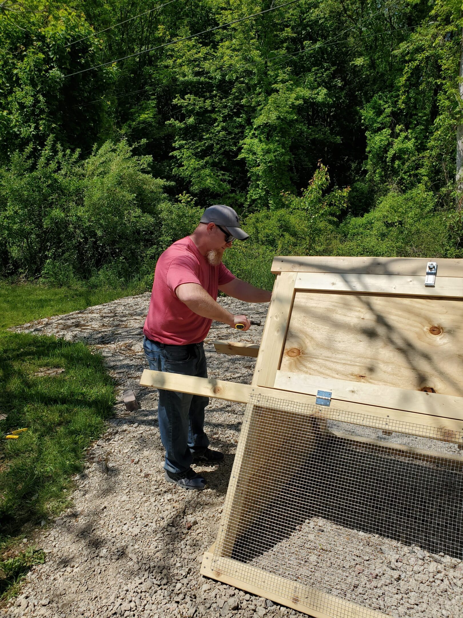 Man working on outdoor wooden structure.