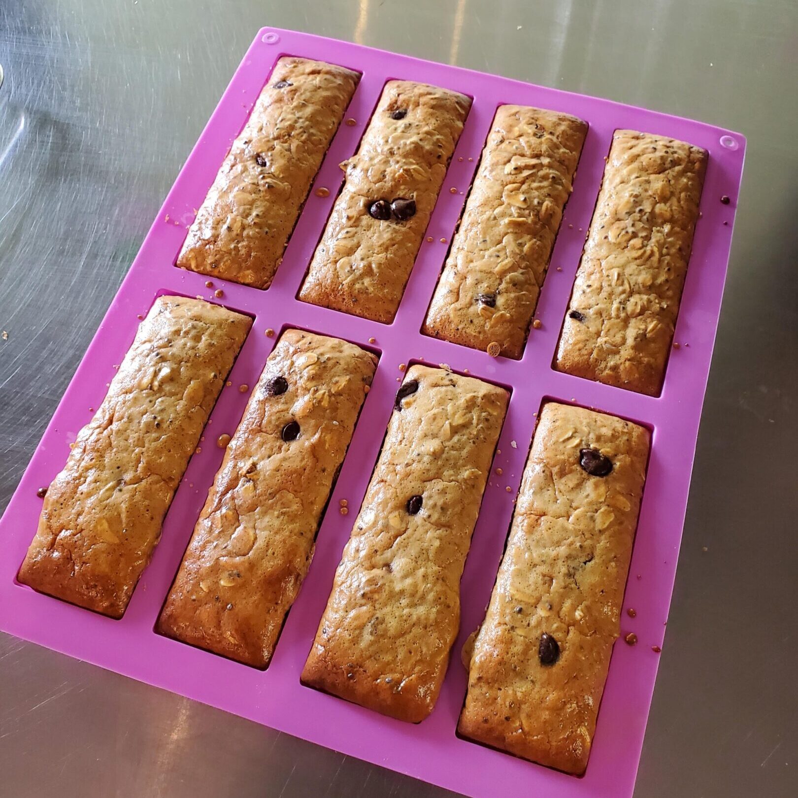 Granola bars in a purple silicone mold.